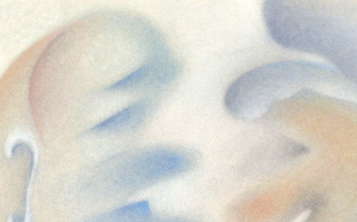 Close-up of a hand holding a white card with abstract watercolor or pastel artwork, featuring blue, orange, and gray tones.