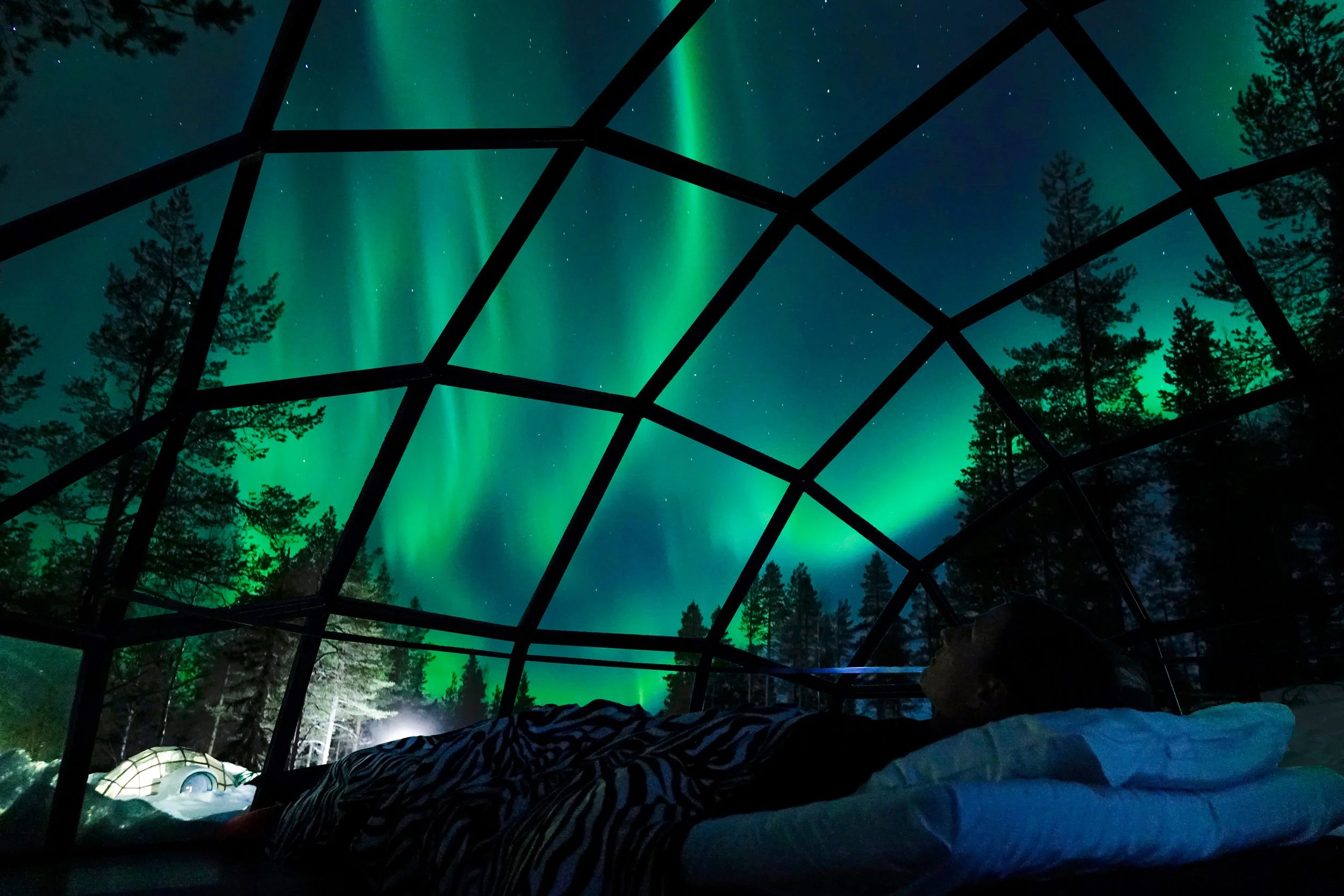 Northern Lights viewed from luxury glass igloo in Finland — Tidal & Rare multigenerational travel experiences