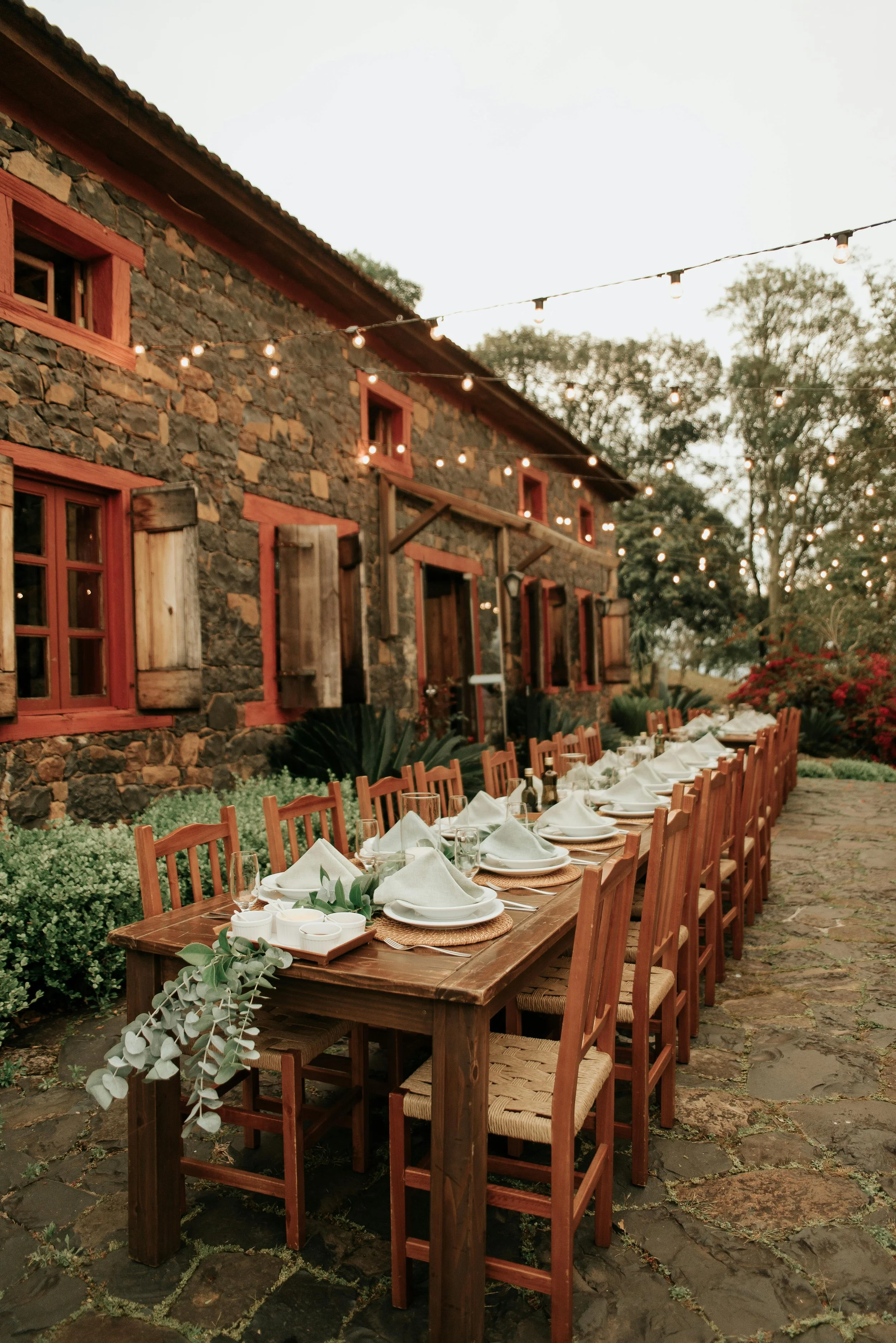 Elegant outdoor dining table set for a group celebration at a rustic stone villa in Tuscany — Tidal & Rare luxury group travel