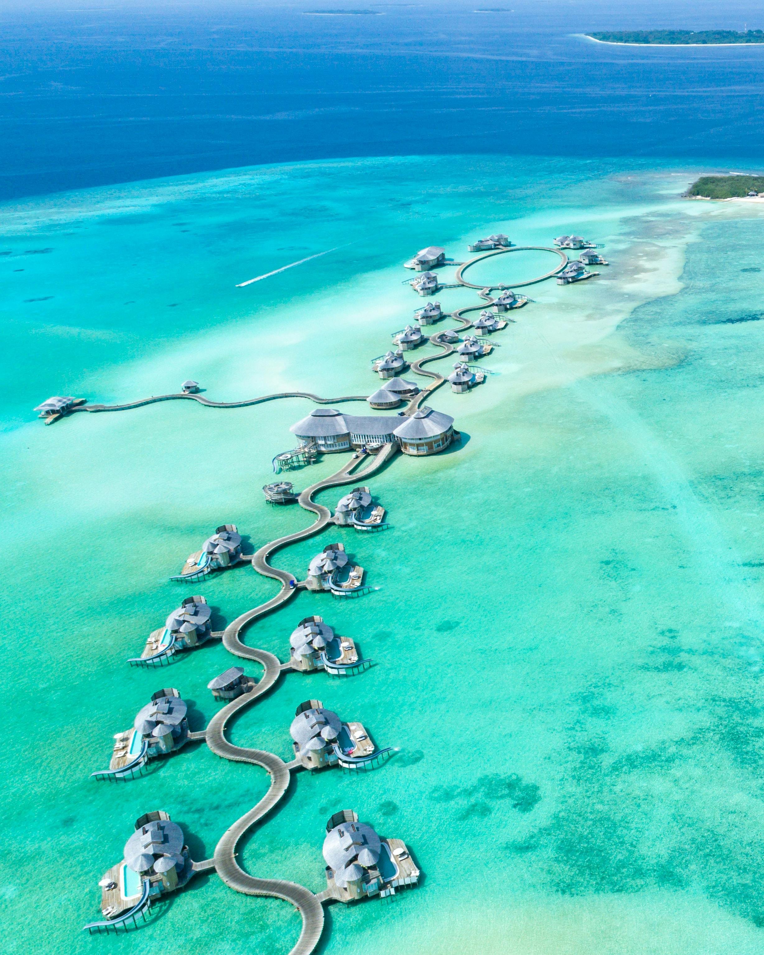 Overwater villas. Infinite blue. The kind of stillness that resets something inside you.