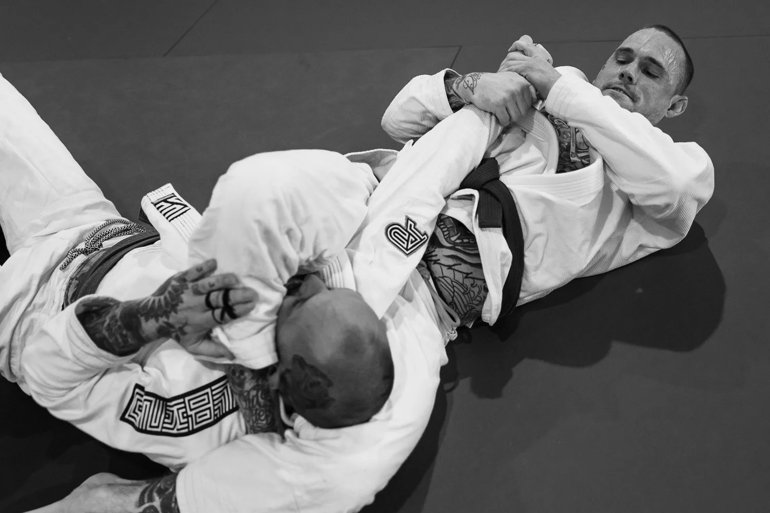 Two Brazilian Jiu-Jitsu practitioners grappling
