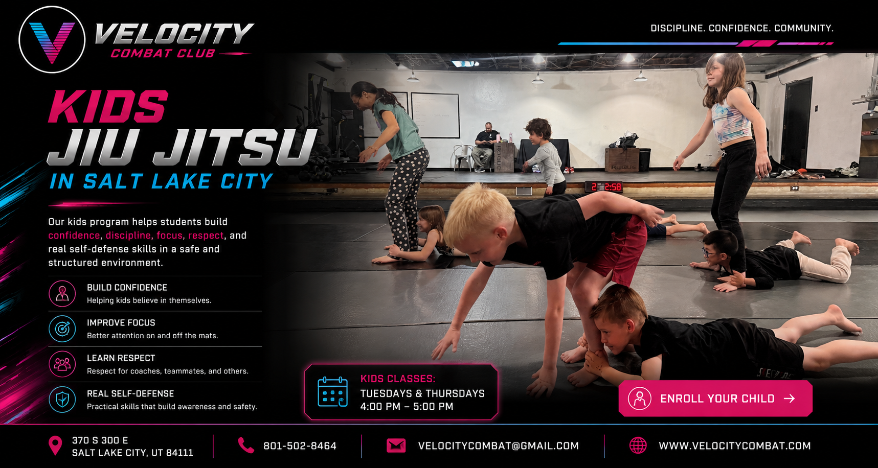 Children participating in a kids Jiu Jitsu class at Velocity Combat Club, Salt Lake City, with a couple of instructors and an observer in the background, on a black mat.
