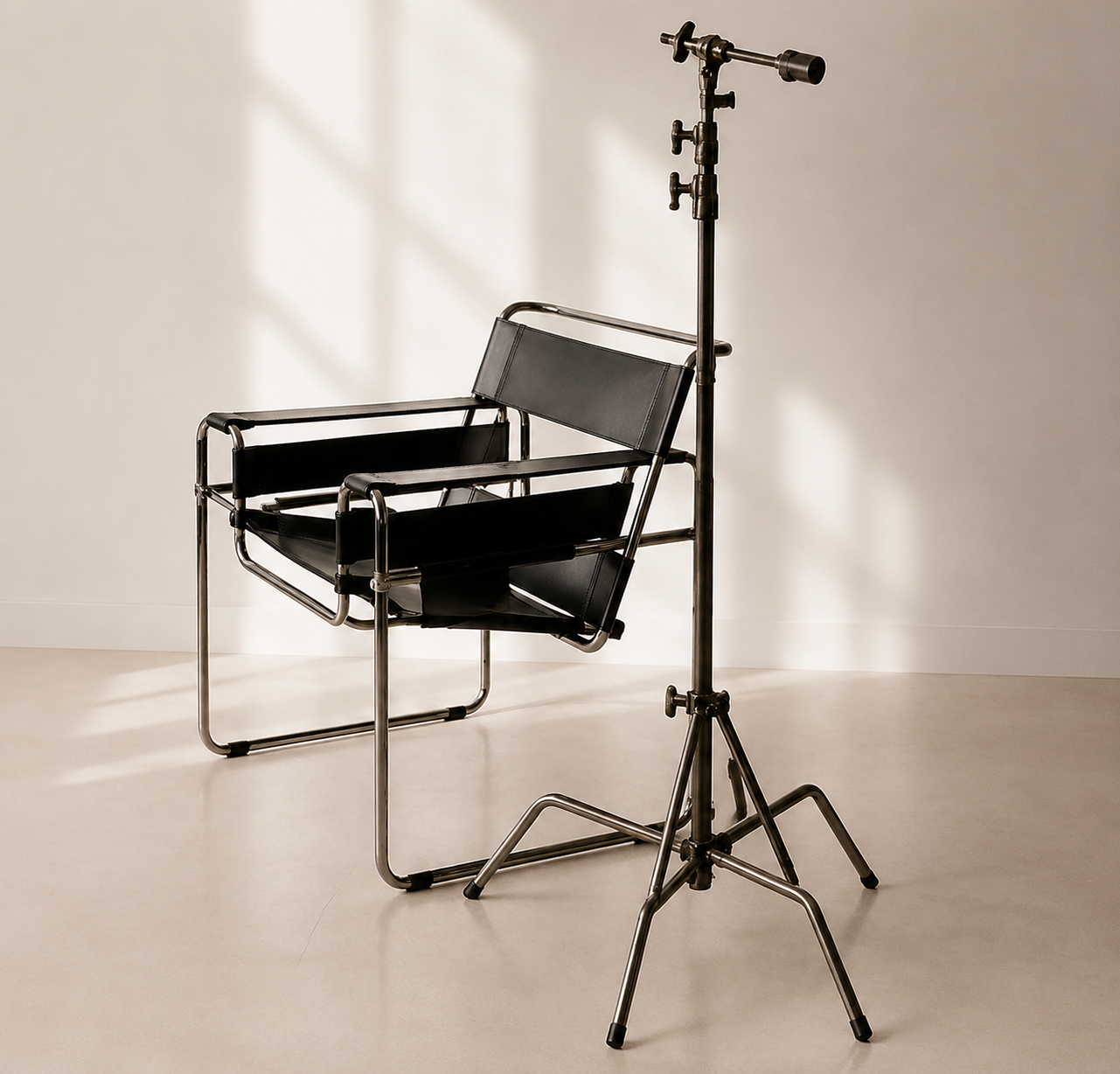 A medical or clinical chair with a metal frame and black leather seating, positioned next to a stand with an adjustable lens or viewing device against a plain beige background.