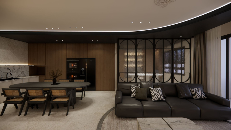 Modern living room and kitchen with black leather sofa, a round dining table with six chairs, a black refrigerator, and wooden cabinetry, illuminated by recessed ceiling lights.