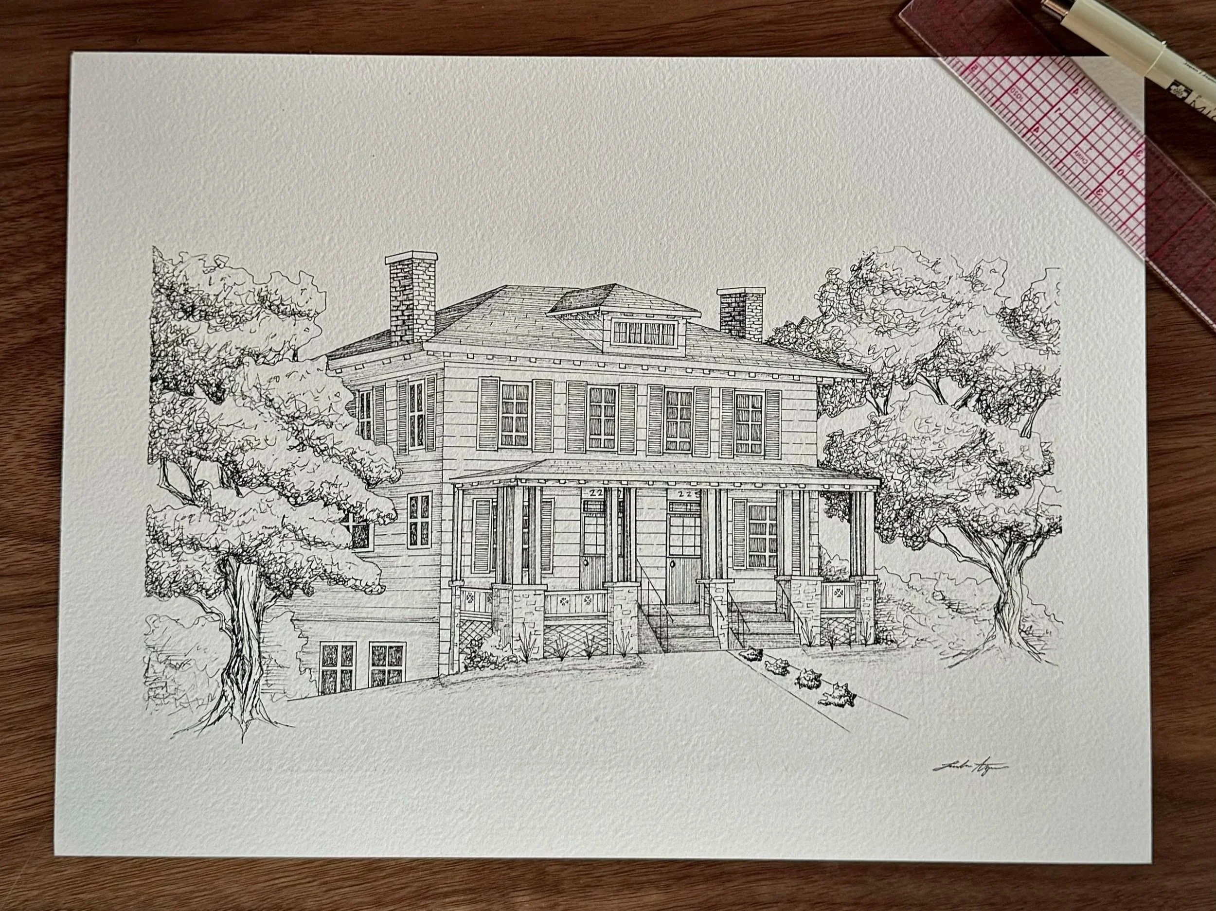 A detailed black-and-white architectural drawing of a house with trees on either side, signed by the artist in the bottom right corner.