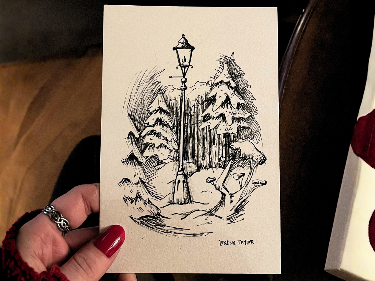 A black and white ink drawing featuring tall pine trees, a streetlamp, mushrooms, and foliage, signed by London Taylor.