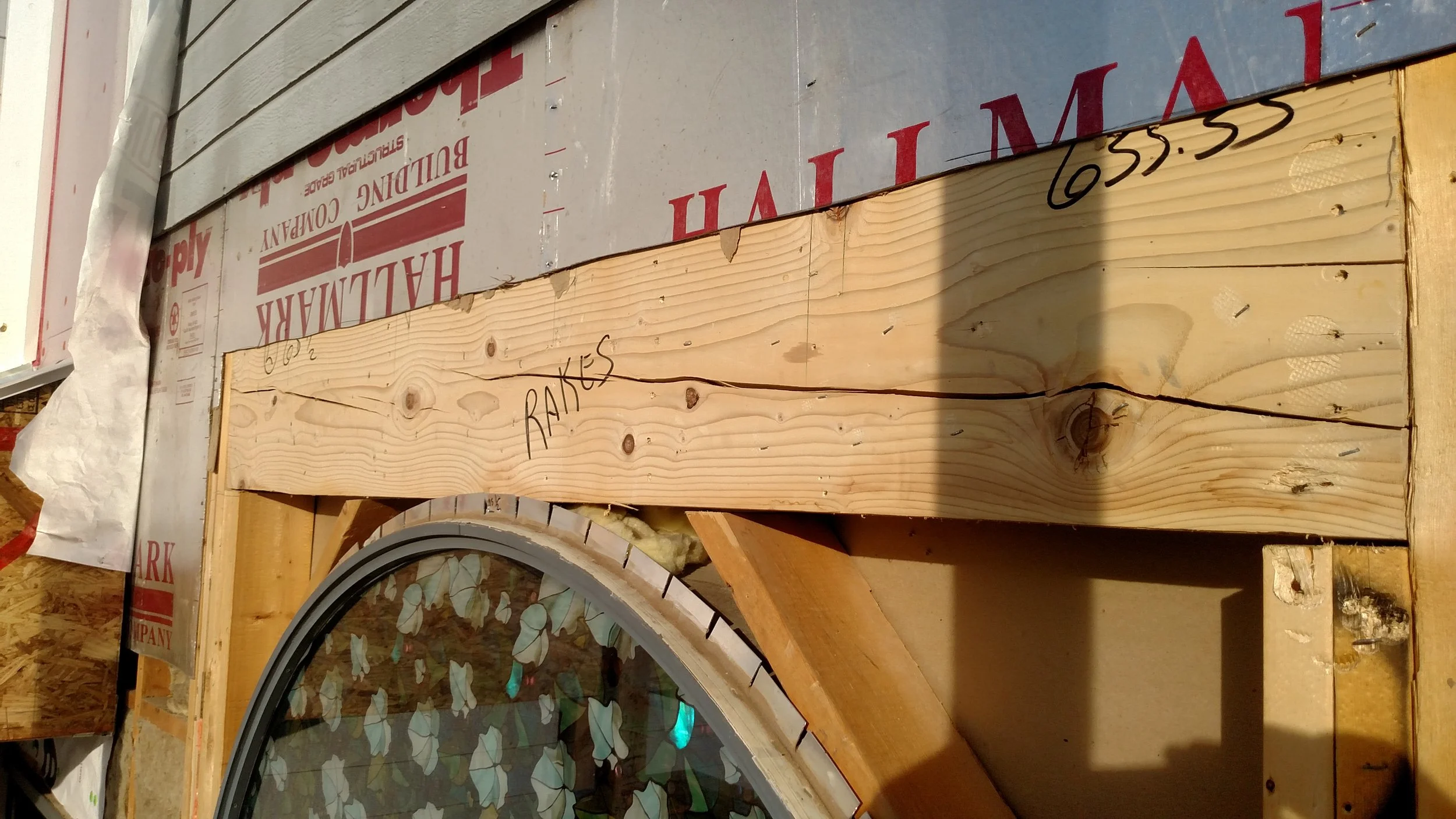 Cracked window header. the silver above is therma ply.    Cheap builder grade substitute for OSB