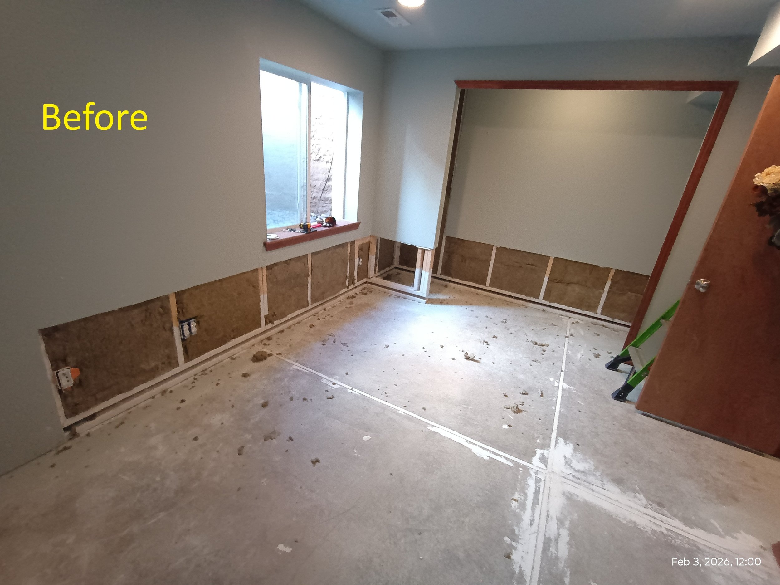 Before photo. Water damage to basement bedroom. Exposed wall studs and missing insulation and drywall