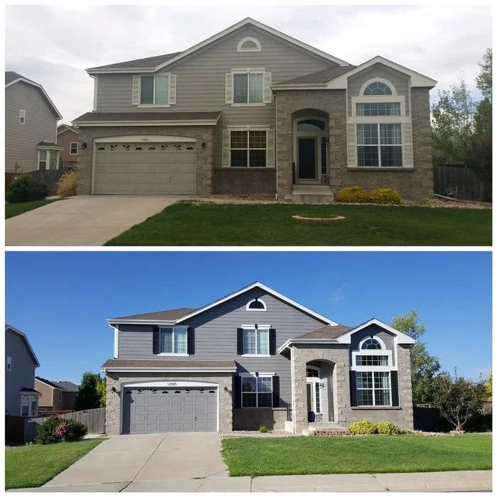 Side-by-side photos of a two-story house before and after renovation. The house has a two-car garage, arched window above the entrance, and a small front lawn. The before image shows a house with pale siding and minimal landscaping. The after image features a darker blue siding, a more defined landscaping with bushes, and a more polished look.