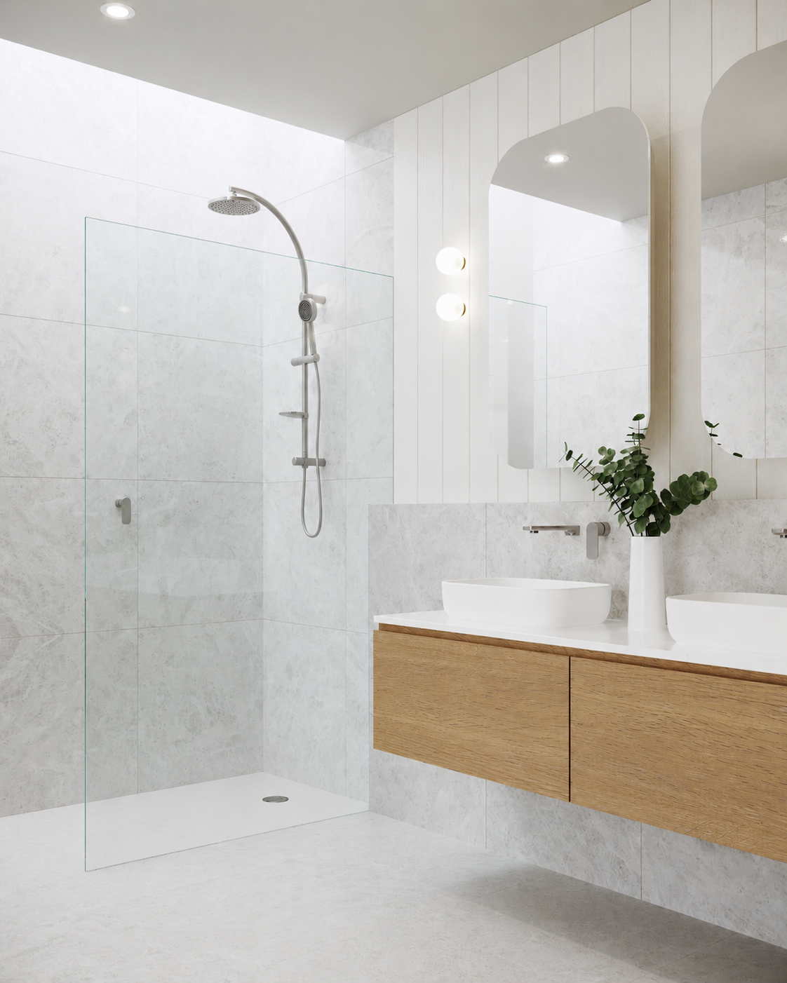 Modern bathroom with a walk-in shower, white marble tiles, a large mirror, a wooden vanity with two vessel sinks, a green plant in a white vase, and minimalist lighting fixtures. Formed Solid Surface