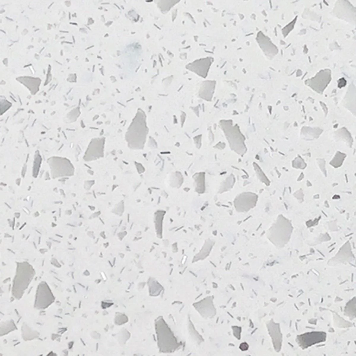Close-up photo of a white speckled Solid Surface, resembling an irregular gray and white chips.