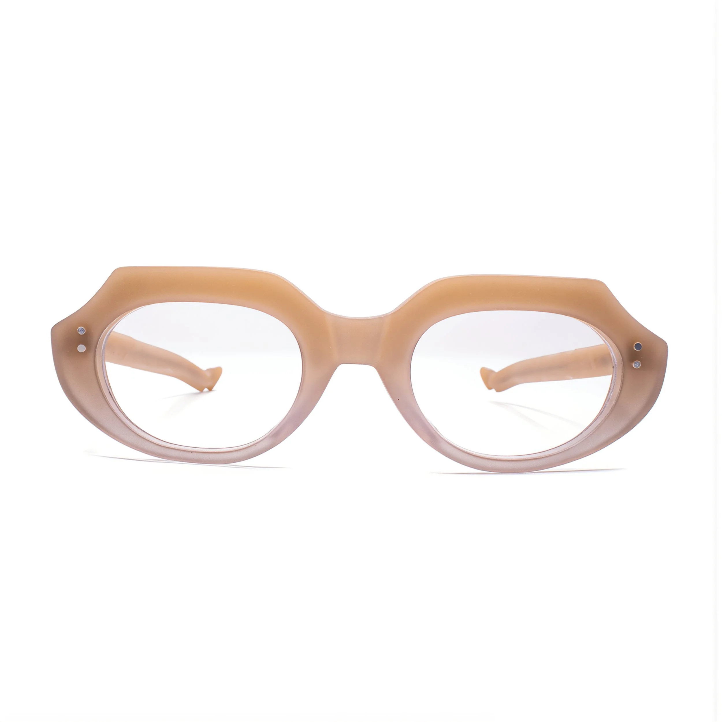 A pair of beige eyeglasses with round frames resting on a white surface.