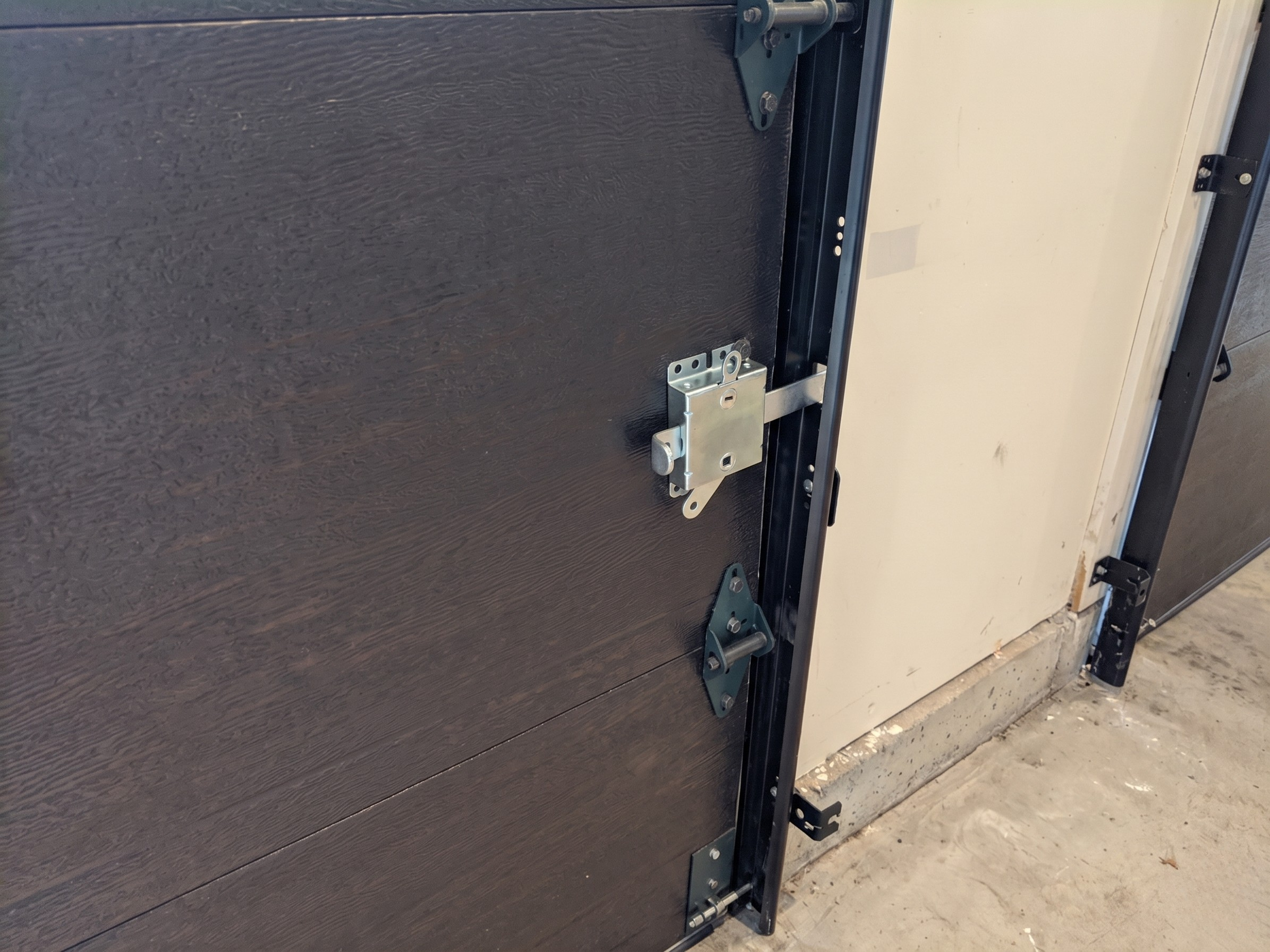Bolt lock installed on garage door track to prevent forced entry from outside