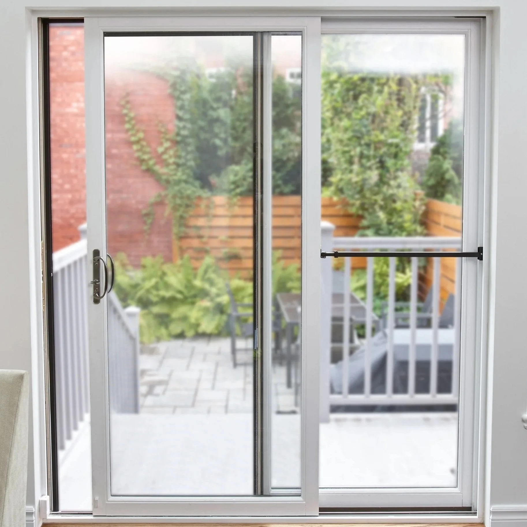 Sliding patio door with security bar installed to prevent forced entry