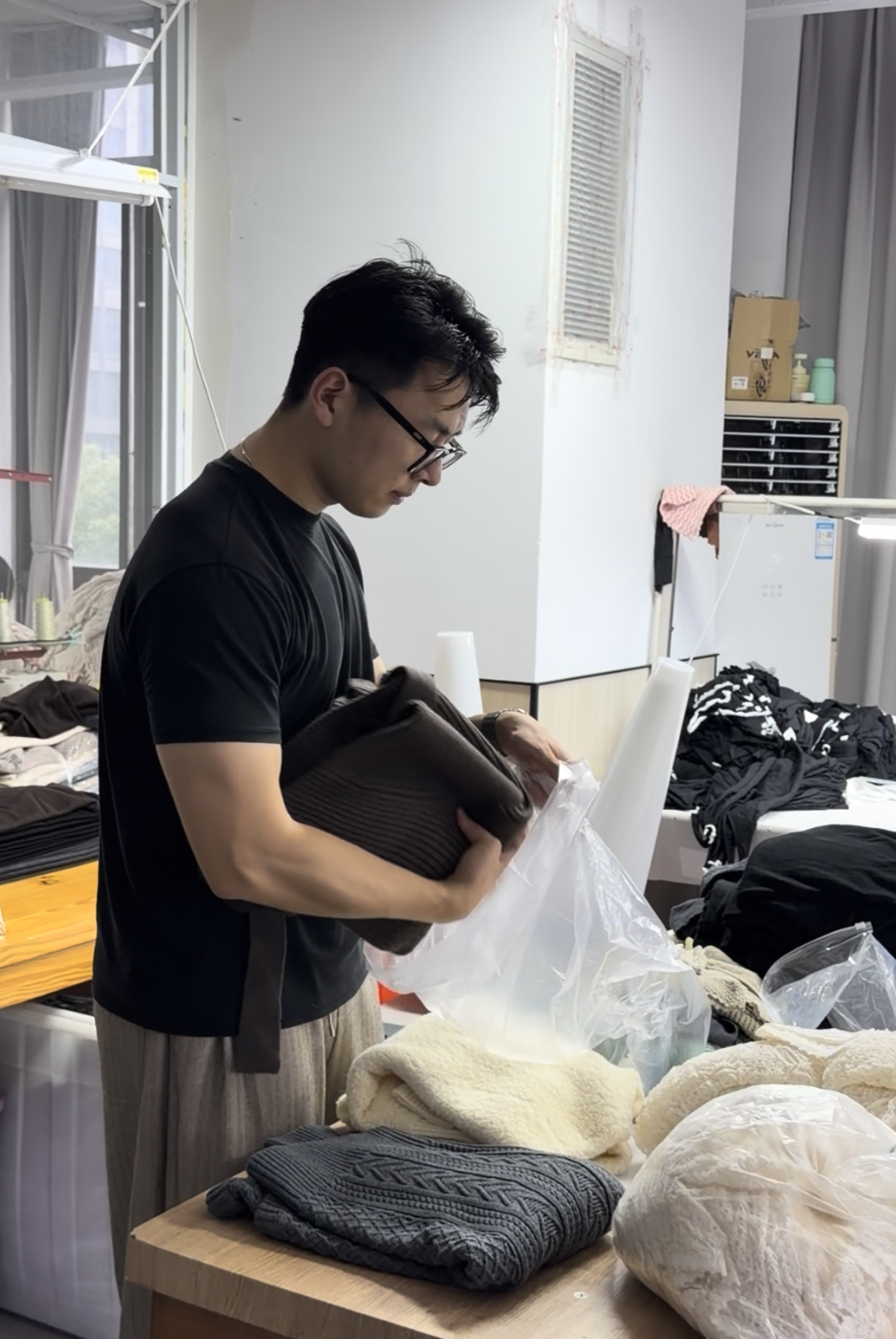 bryce is checking the knitwear sample with colleagues