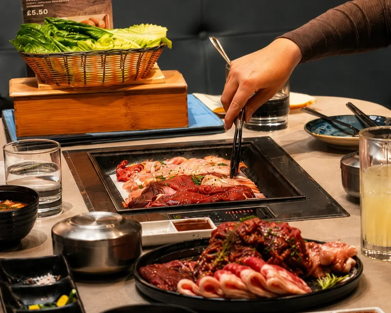 Guest grilling premium Korean BBQ meats at the table in Central London