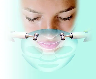A person receiving a facial treatment with two handheld devices applying facial therapy.