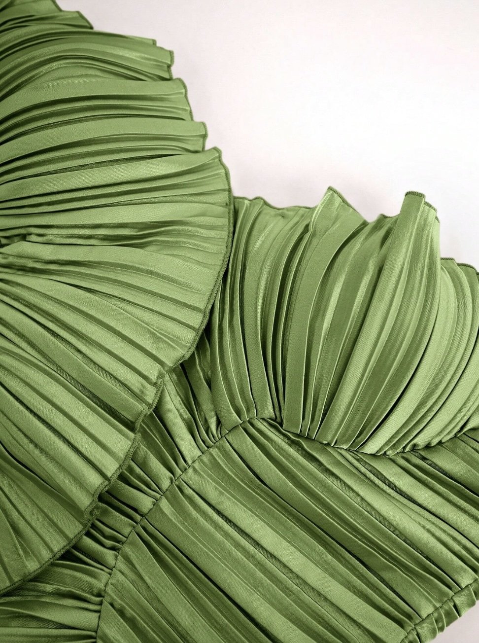Detail of the Estelle Top with pleated green satin fabric.