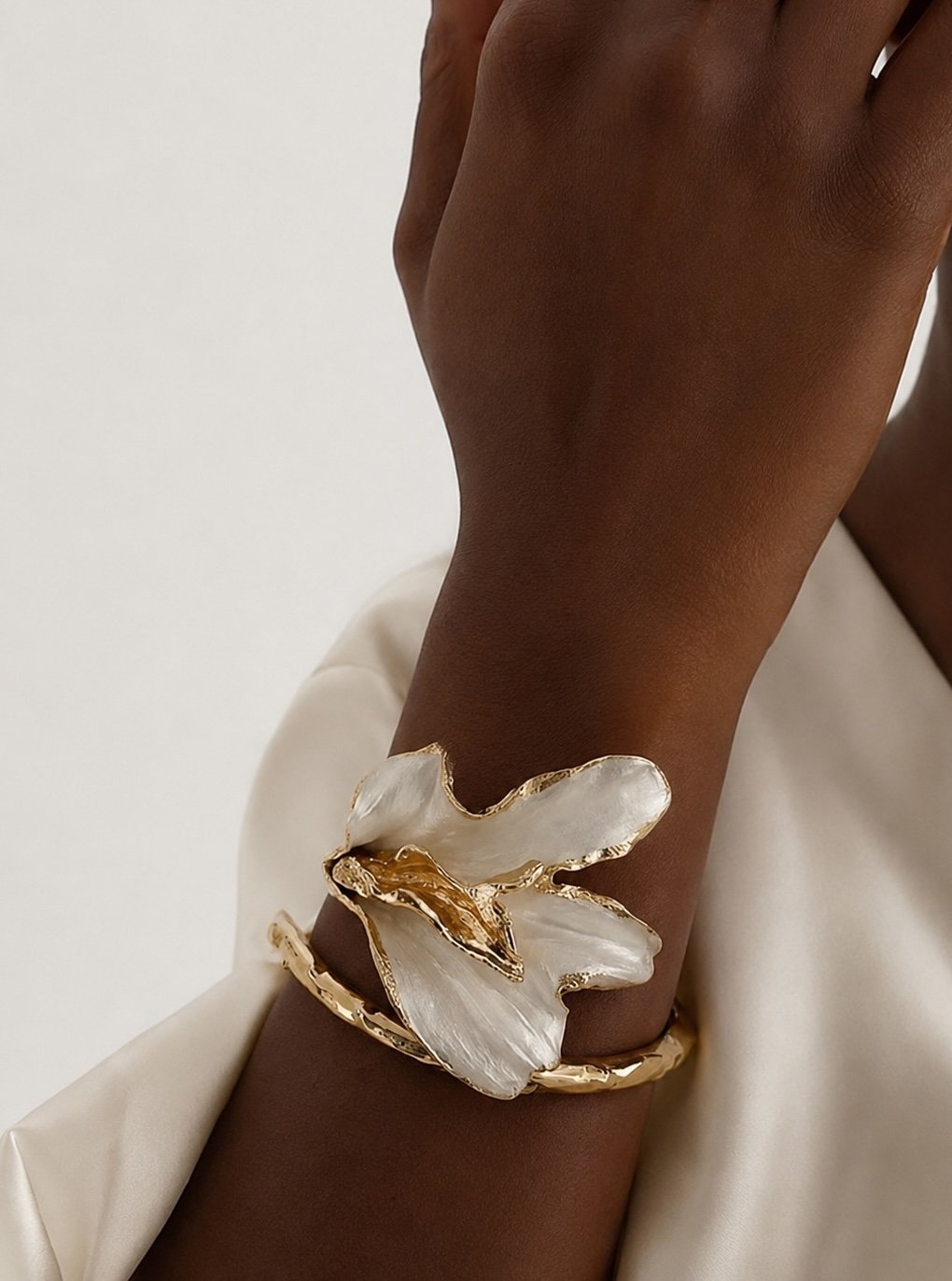 Gold-plated Calla Cuff bracelet shaped as a calla lily worn on the wrist.