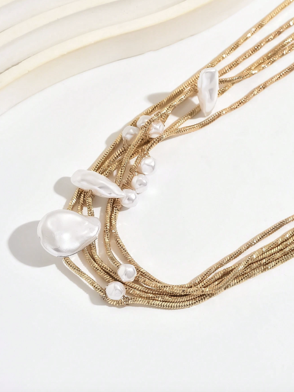 Solenne Necklace with layered mother-of-pearl accents and gold-tone chain detailing.