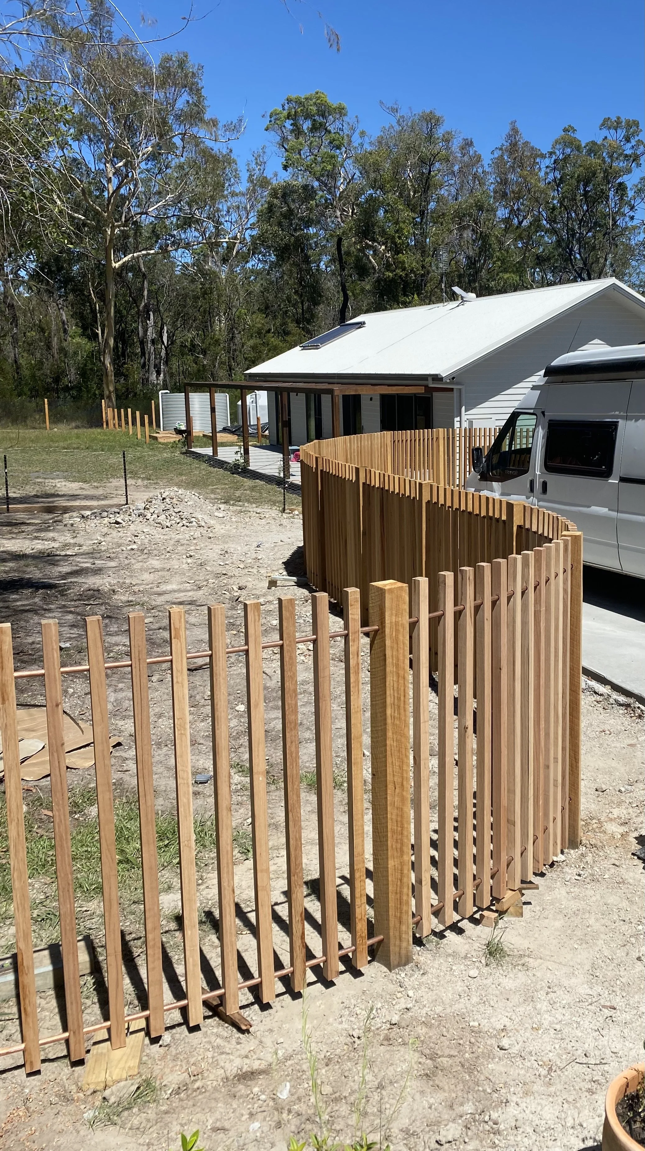 42x42 black butt battens and copper tubing rails. Curved fencing. Feature Fence.