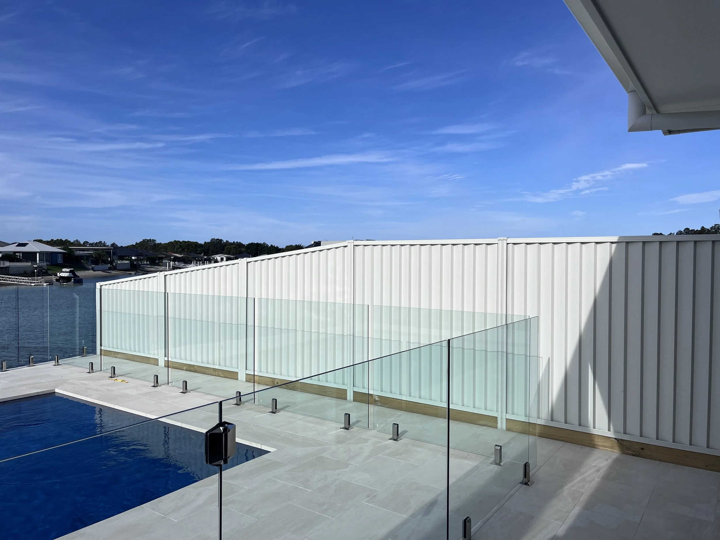 Surfmist Sawscreen Colorbond fencing and frameless glass pool fencing.