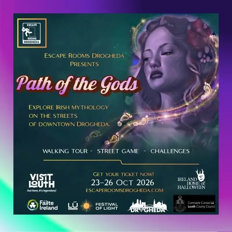 "Path of the Gods" presented by Escape Rooms Drogheda, exploring Irish mythology through street activities in downtown Drogheda from October 23 to 26, 2026. The poster features a stylized portrait of a woman with flowing hair, surrounded by swirling golden magical effects, and includes logos of sponsors and partners.