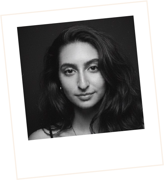 Polaroid black and white image of Holly smiling calmly at the camera with long wavy dark hair