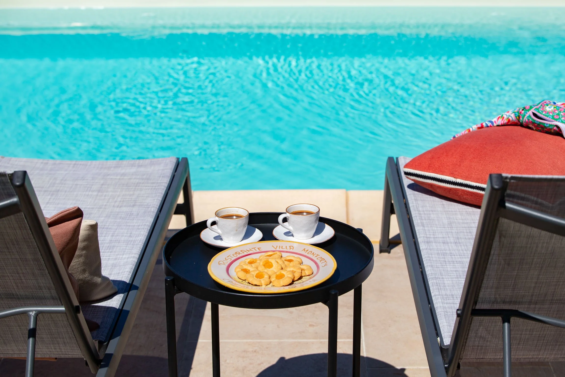 Even the pool area has design touches to keep everyone fed and watered. Simple tables by each sun lounger has your food and drink covered.