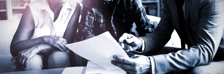 People in a business meeting discussing documents.