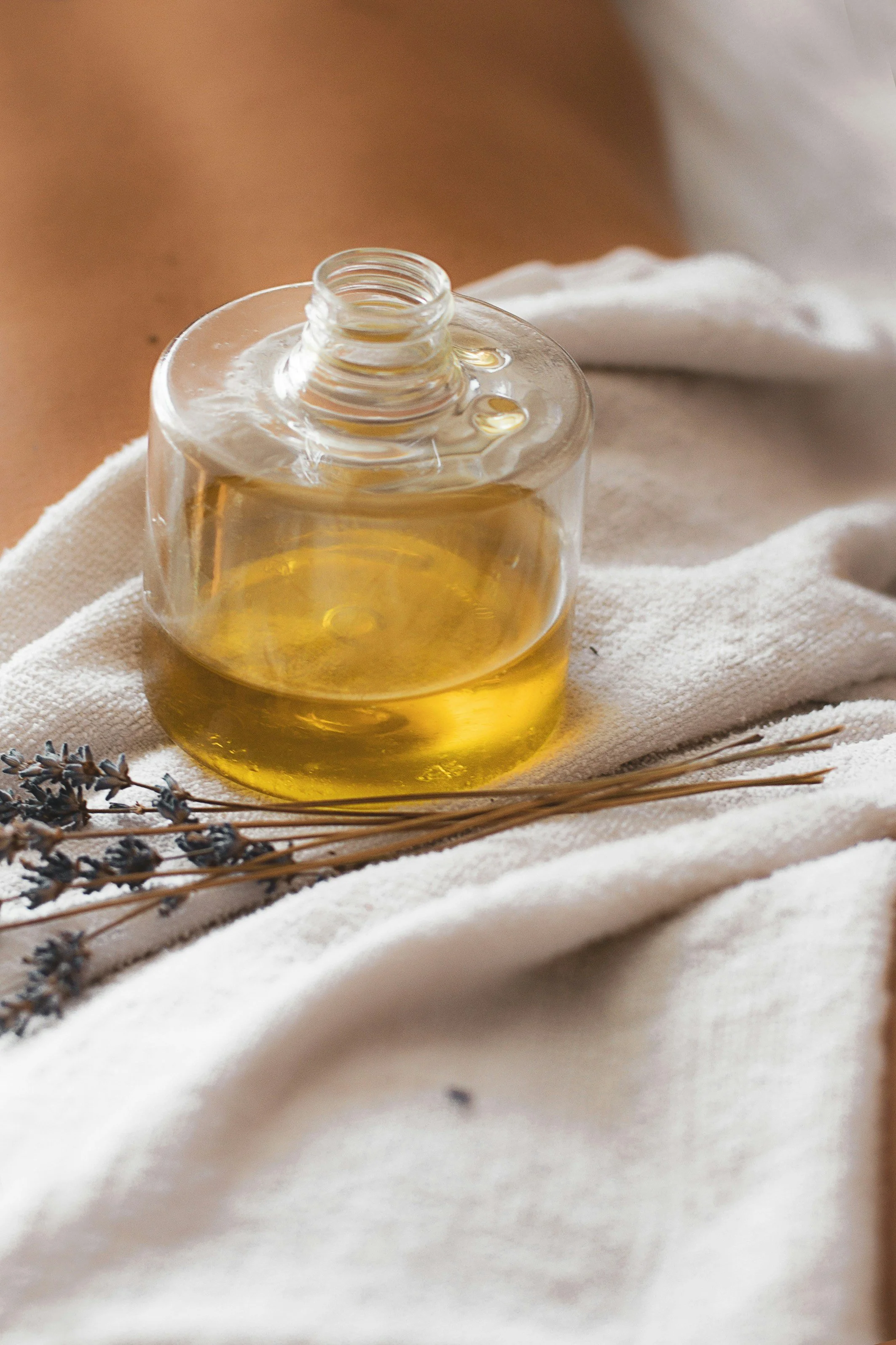 Massage oil and lavender leaf on client's back during a therapeutic massage session