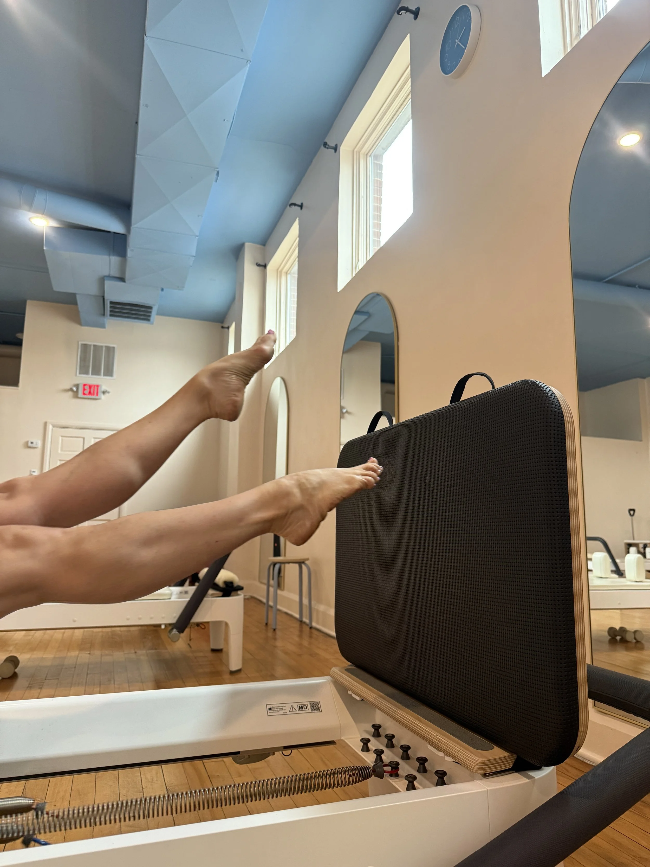 Reformer Pilates training session helping a client enhance core engagement, coordination, and overall body awareness in a welcoming Columbus Pilates studio.