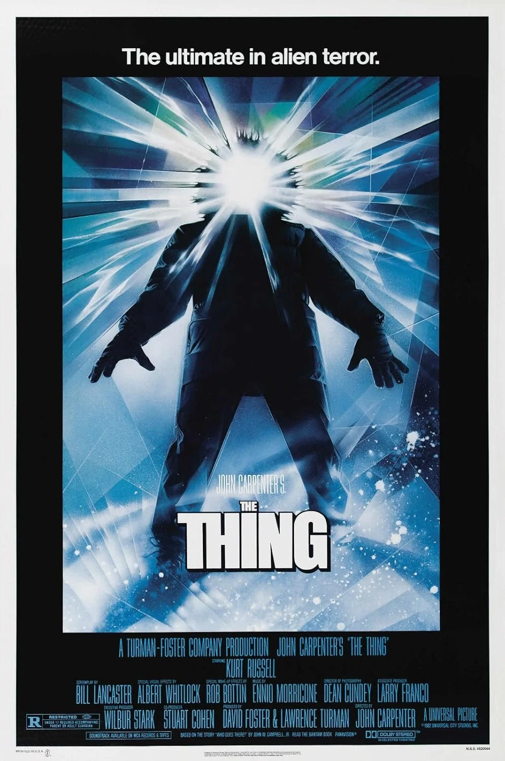 Movie poster for John Carpenter's 'The Thing' featuring a silhouette of a figure with a bright light exploding from its face, surrounded by blue and white icy and abstract elements, with the tagline 'The ultimate in alien terror.'