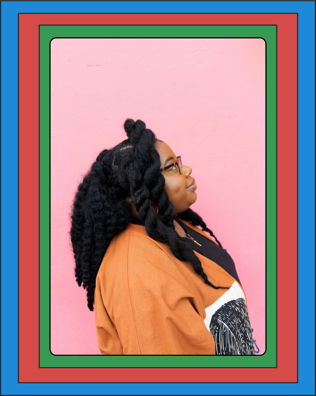 Profile of a woman with dark curly hair styled in twists, wearing glasses, a nose ring, and a black shirt with a white graphic, standing against a pink wall, framed with colorful border.