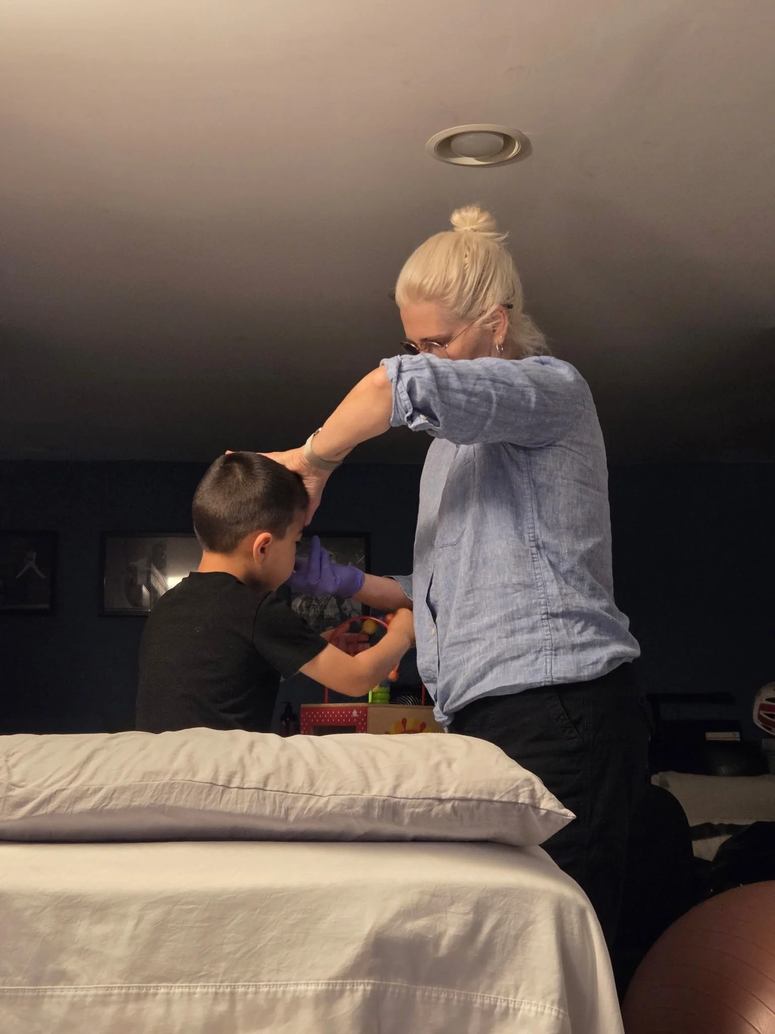 Carrie giving craniosacral therapy to a 5 year old boy after a frenctomy