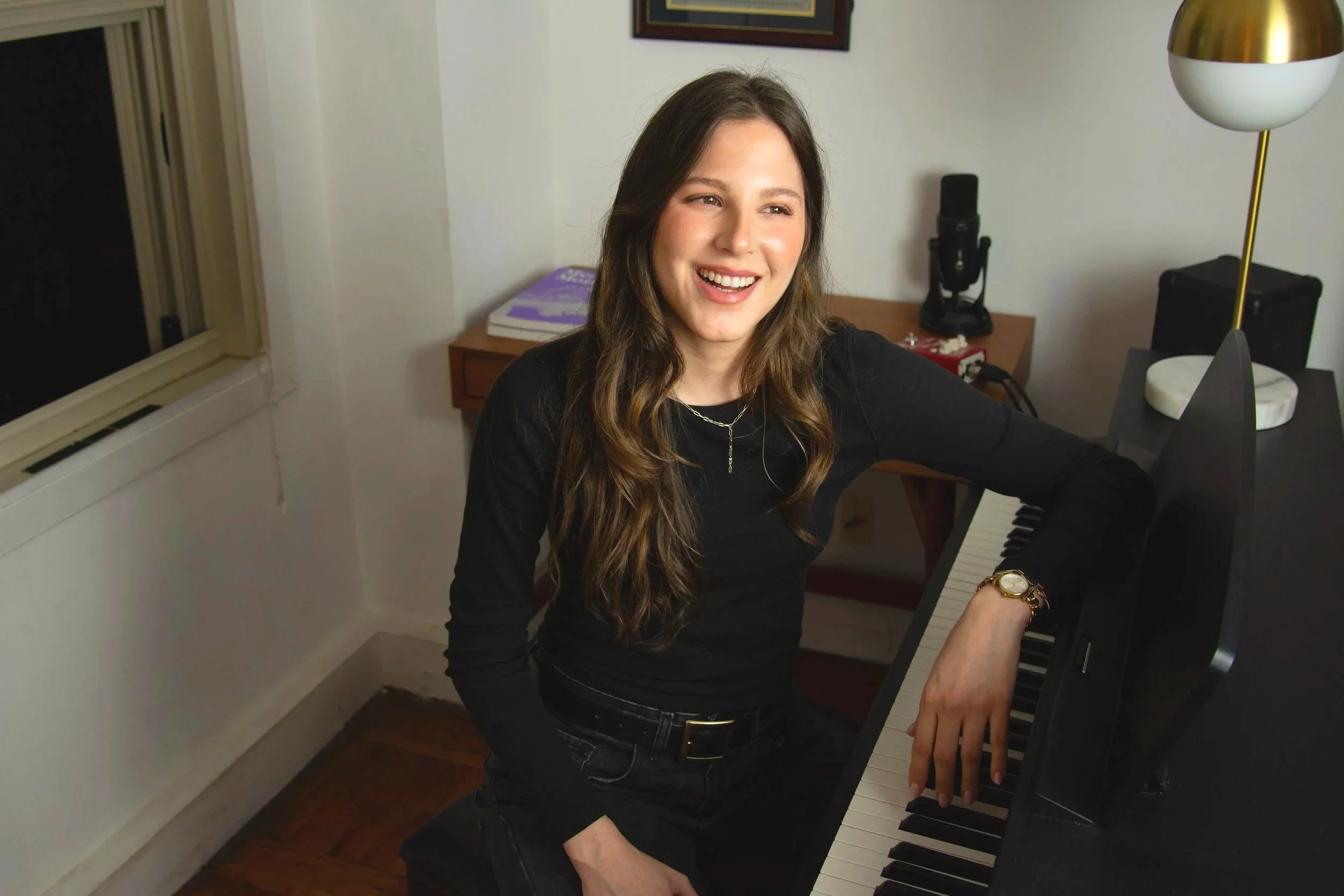 Elana Hedrych, voice teacher and founder of The Vocal Practice, at the piano in her New York City studio