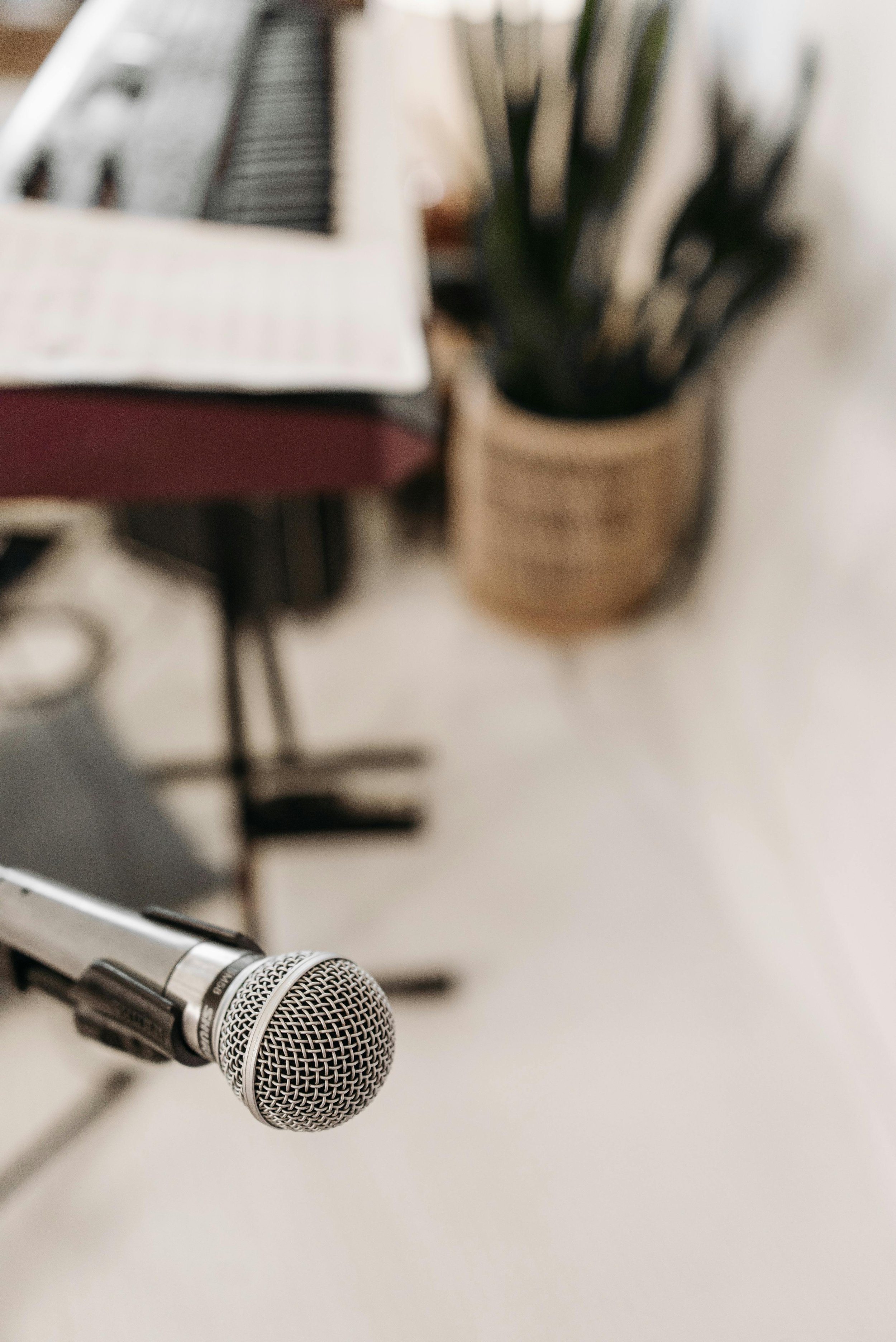 Microphone in a studio with piano in the background