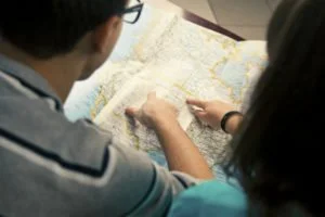 Two people studying a folded map together.