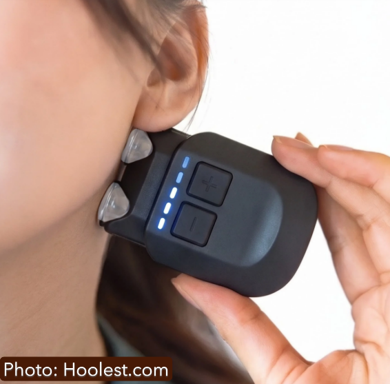 Hoolest VeRelief Prime device held against the side of the neck below the ear during a session.