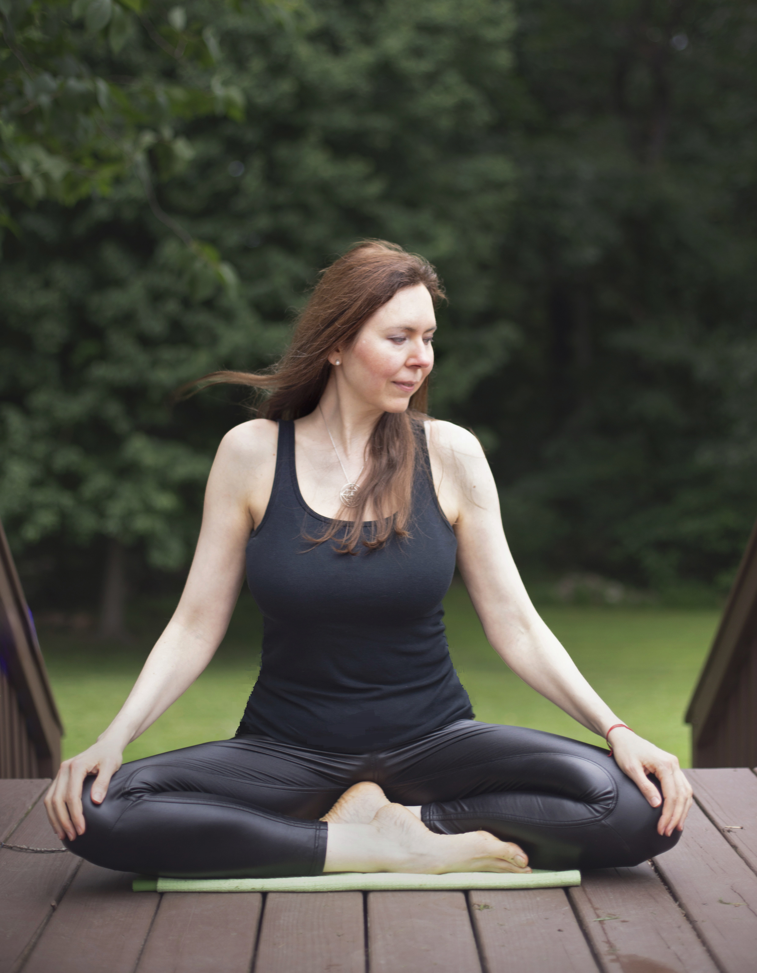 Dr. Lienna Wilson, PsyD, in a seated outdoor breathing and meditation practice