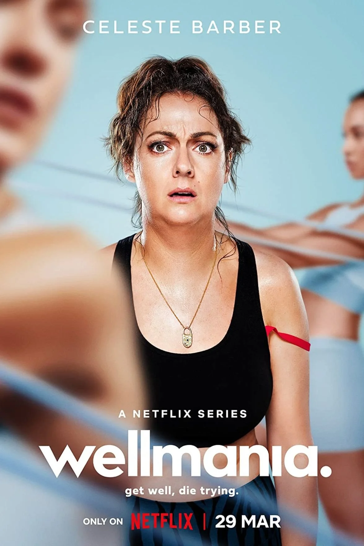 Poster for the Netflix series 'Wellmania' showing a woman with short, messy hair and a surprised or confused expression. Her top has a red ribbon on the right strap, and she is wearing a gold necklace with a capsule pendant. Two other women with toned arms are blurred in the background. Text on the poster indicates the series premieres on March 29.