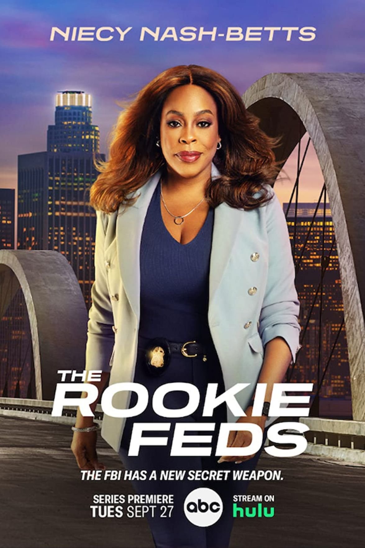 Promotional poster for the TV series "The Rookie Feds" featuring Niecy Nash-Betts, with a city skyline and a bridge in the background, and text indicating the series premiere date of September 27 on ABC and Hulu.