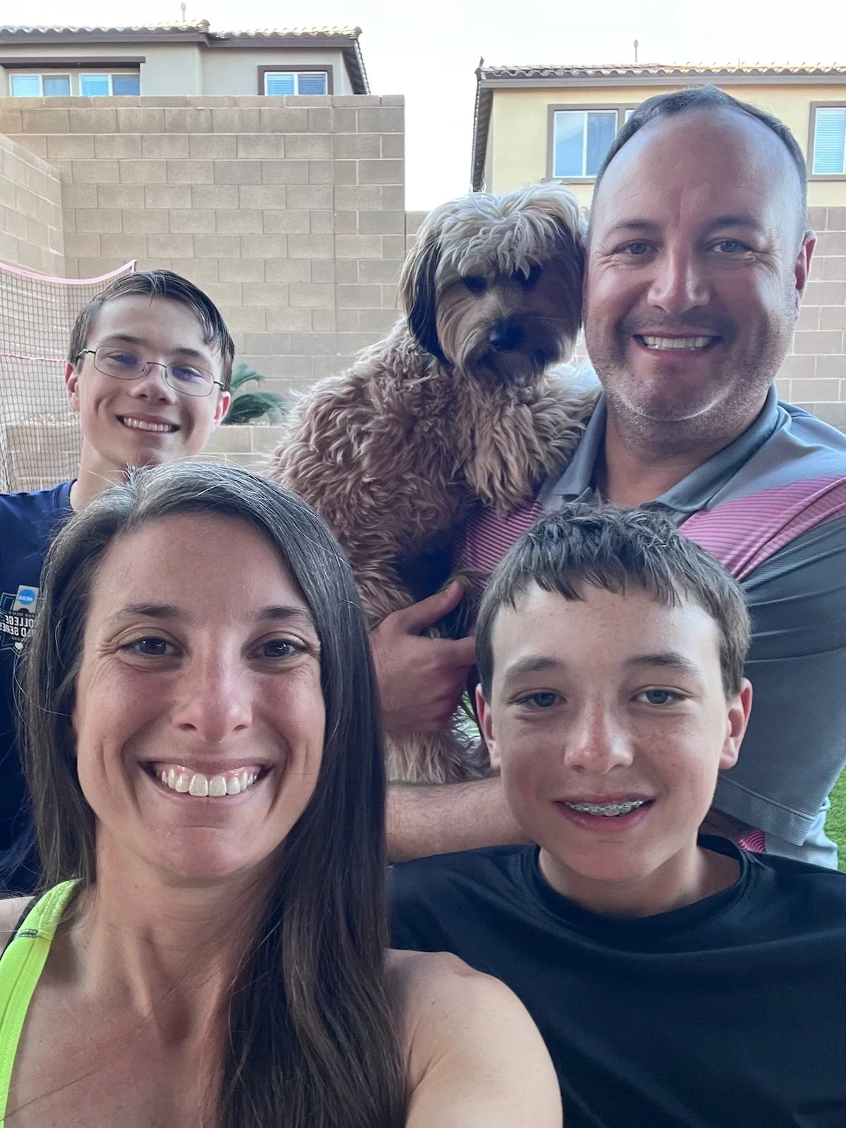 Kristy, Co-Founder of Tidy, at home with her husband, two sons, and their dog.