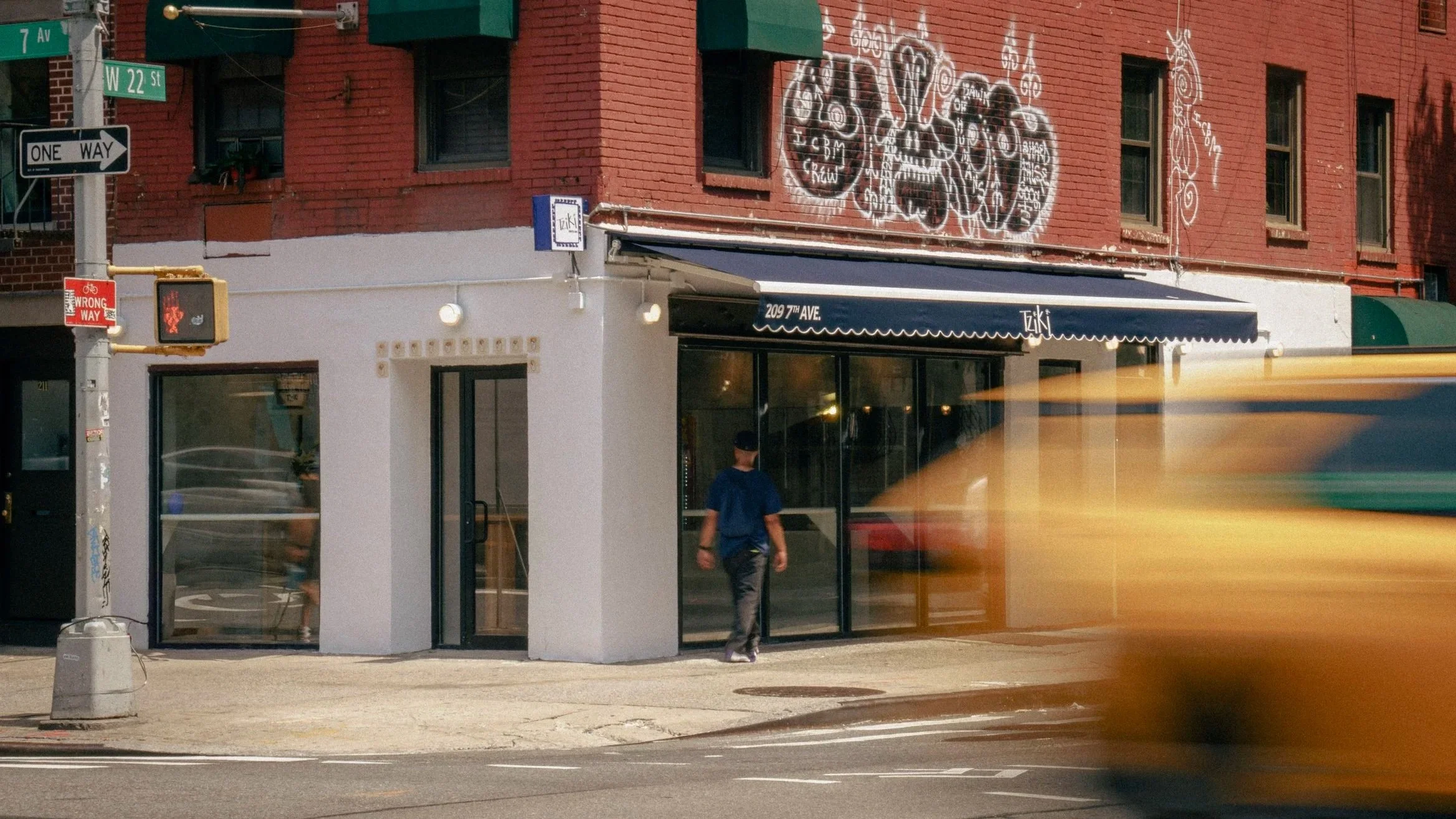 Tziki storefront at 209 7th Avenue, Chelsea, NYC — Athenian souvlaki shop with blue awning.