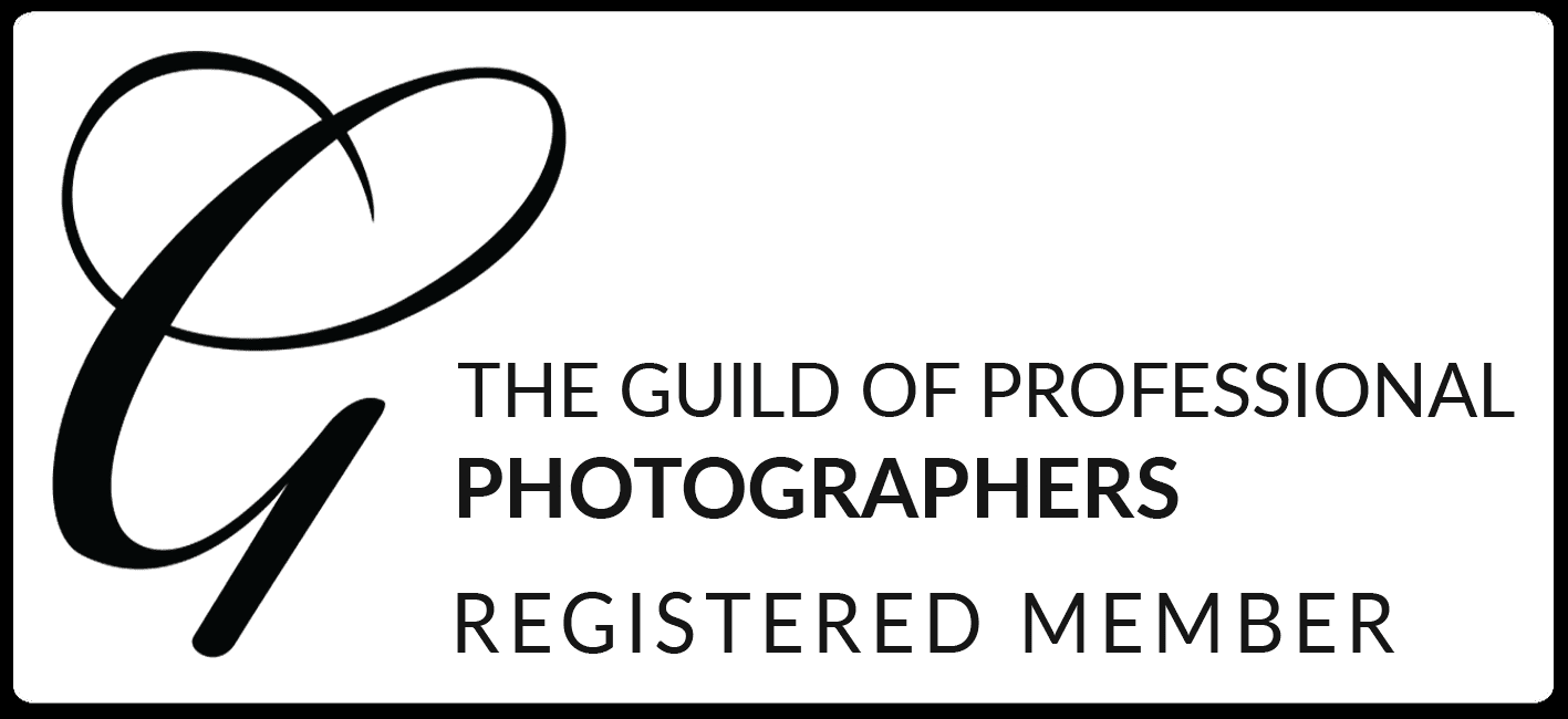 Black and white logo of The Guild of Professional Photographers with a stylized letter G and text indicating registered membership.