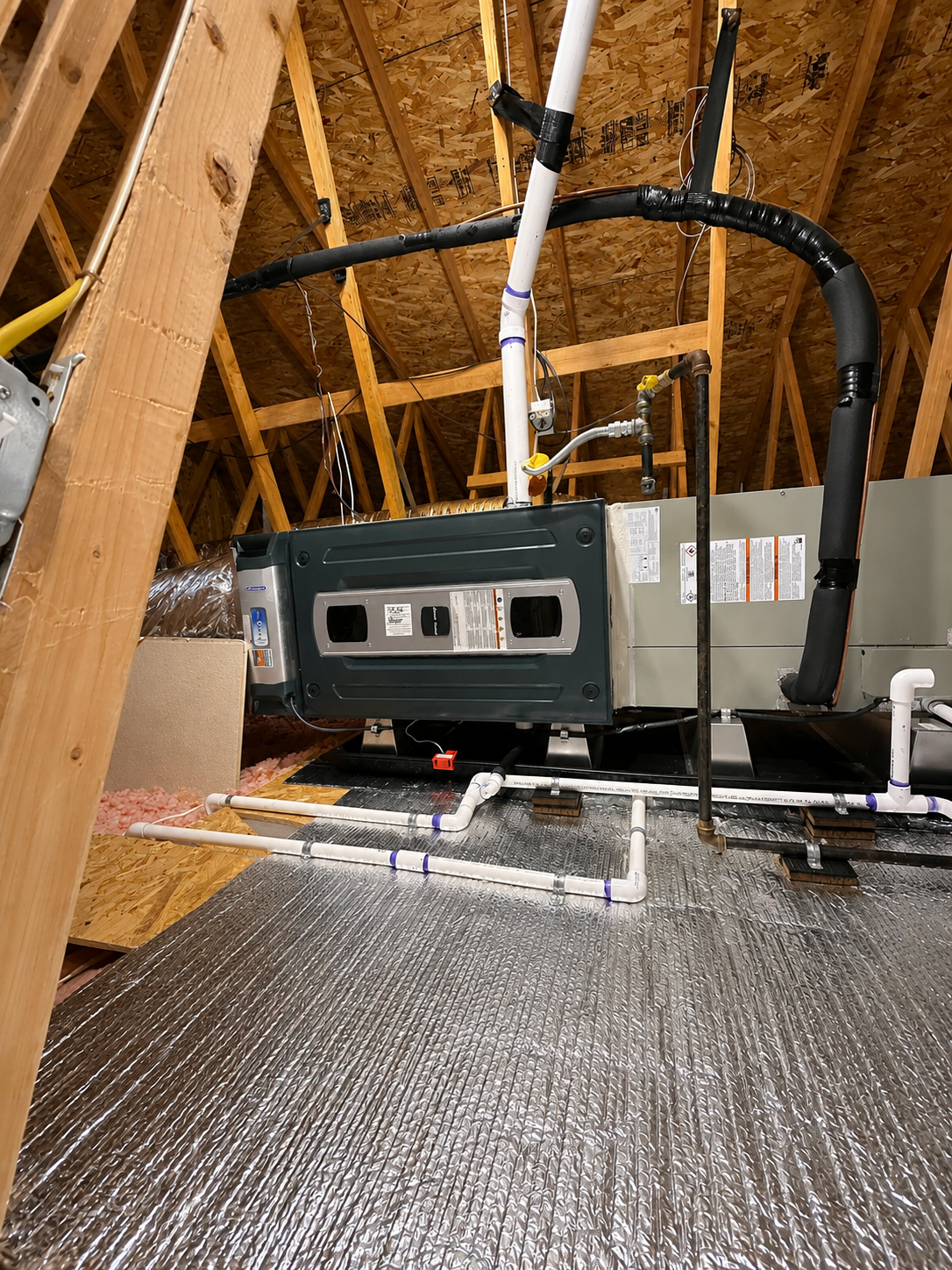 Attic HVAC installation with insulated ductwork and airflow system