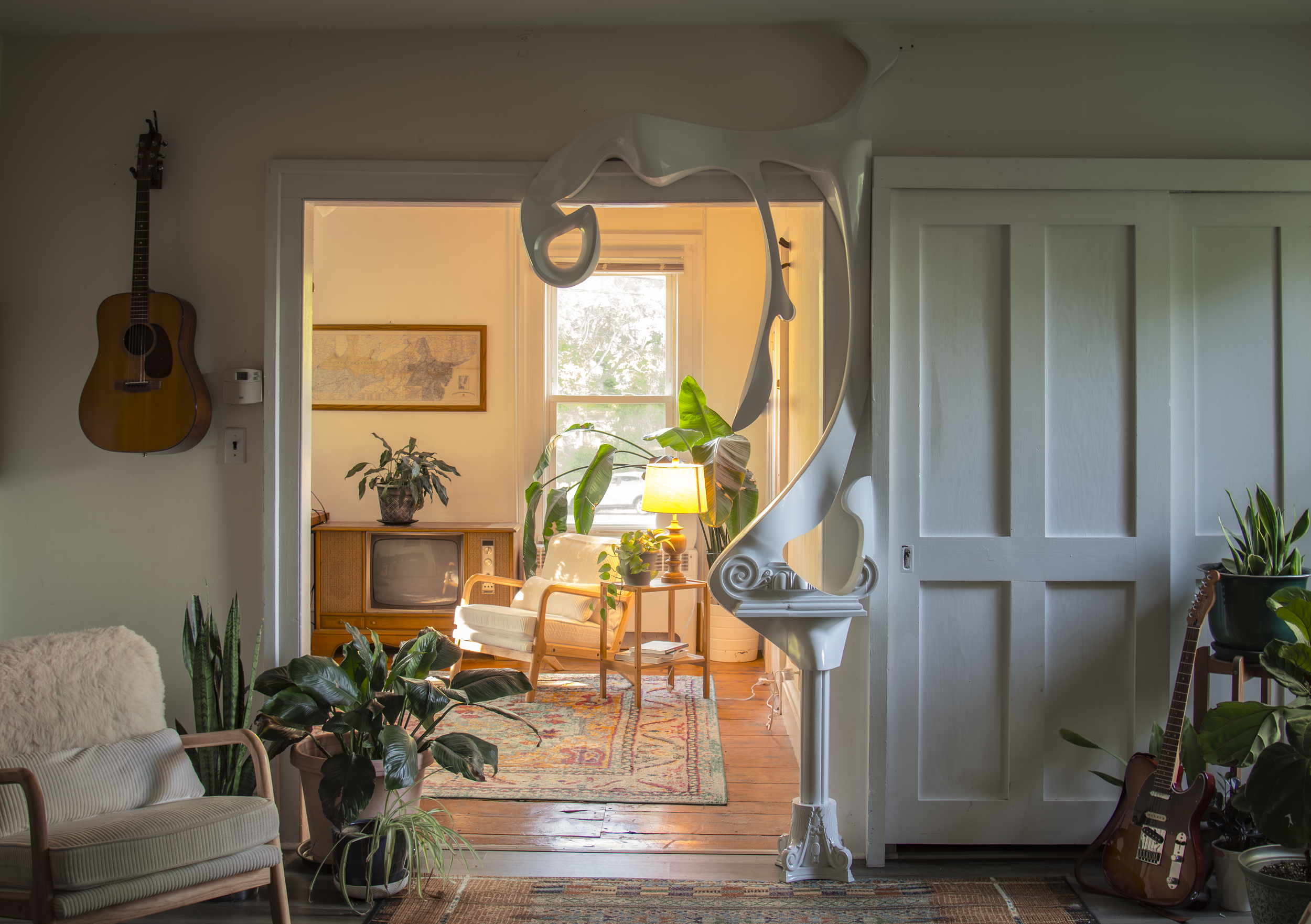 A white architectural ornament accenting an entryway with warm light