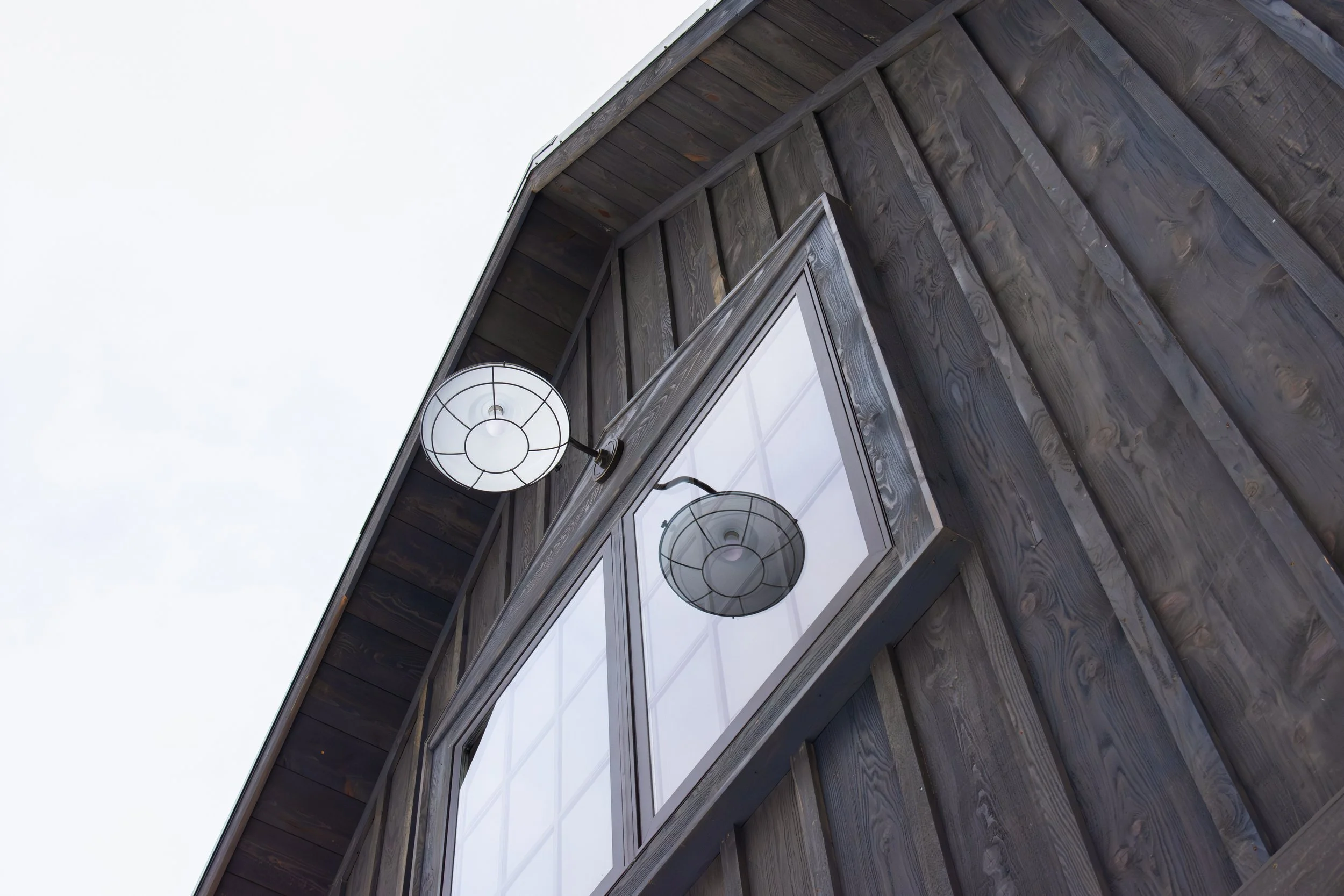 weathered stained hemlock , custom window details and soffit
