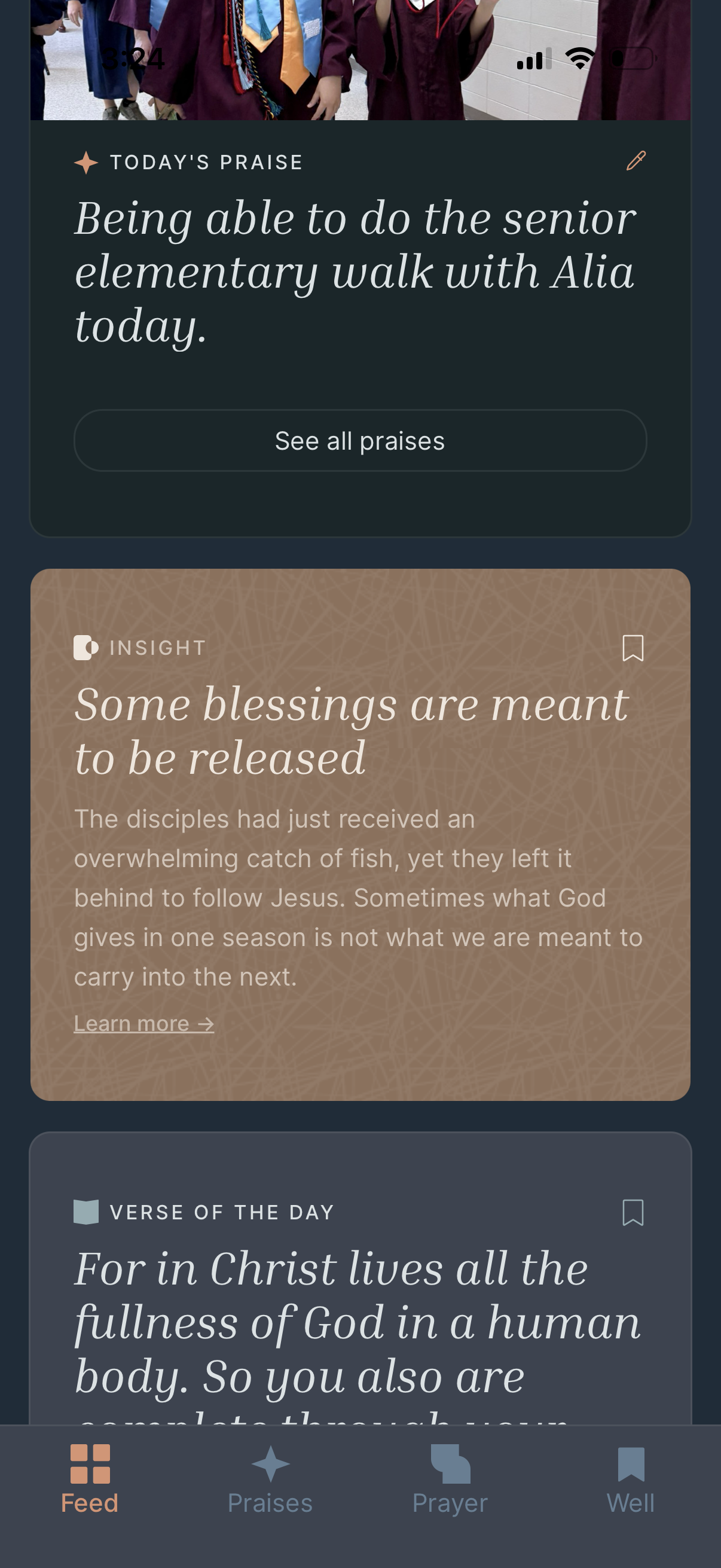 Mobile app screen showing praise, insight, verse of the day, and navigation options at the bottom. A group of people wearing graduation gowns is visible at the top.