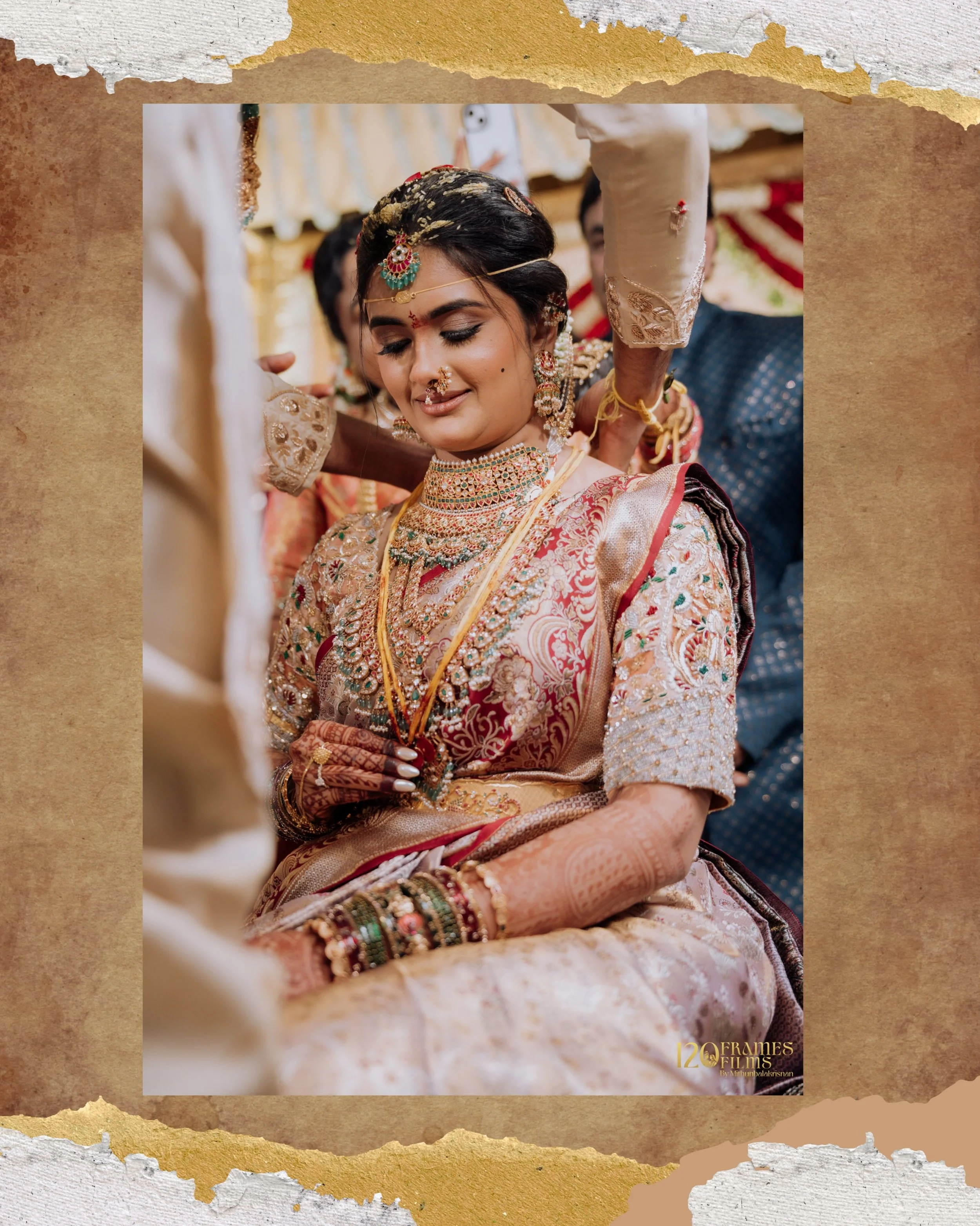 A bride dressed in traditional Indian wedding attire, adorned with intricate jewelry, and surrounded by family members at her wedding ceremony.